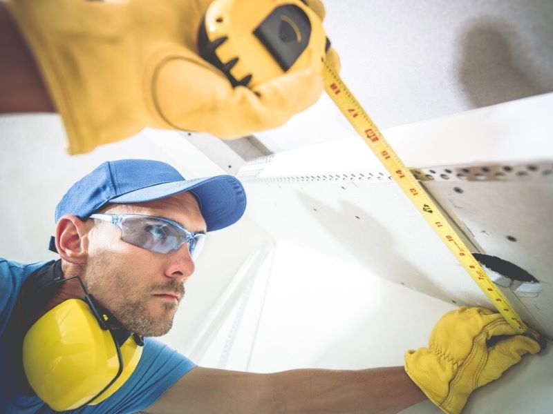 worker using a measuring tape